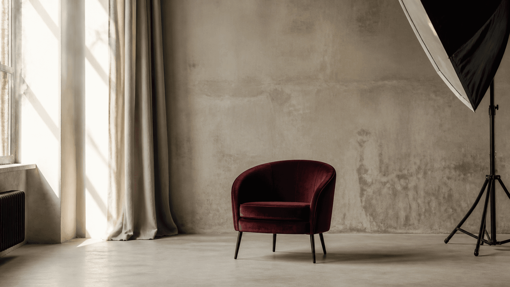 A burgundy chair in a daylight photo studio
